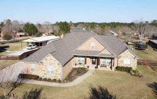 Experienced roofers installing a new residential roof in a suburban neighborhood.