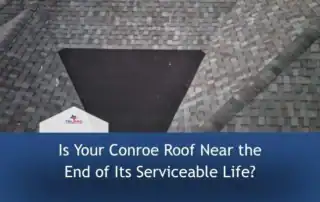 Roofers inspecting a Conroe residential roof for damage.